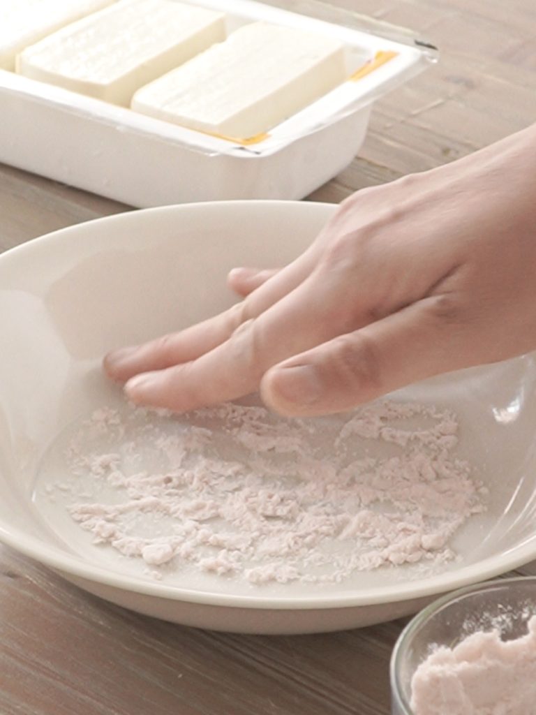 demonstrated one of the steps of salting tofu